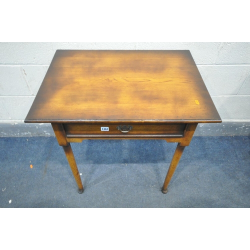 1462 - A REPRODUCTION OAK SIDE TABLE, with a single  drawer, on cylindrical tapered legs and padded feet, w... 