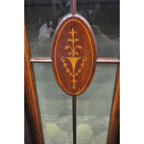 1463 - AN EDWARDIAN MAHOGANY AND MARQUETRY INLAID DISPLAY CABINET, with double bowfront cupboard doors, on ... 