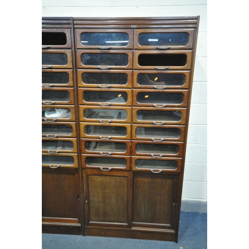 1468 - A PAIR OF EARLY 20TH CENTURY MAHOGANY HABERDASHERY CABINETS, made up of sixteen glass fronted drawer... 