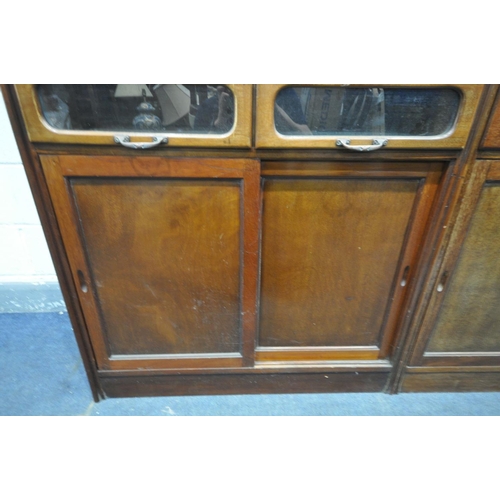 1468 - A PAIR OF EARLY 20TH CENTURY MAHOGANY HABERDASHERY CABINETS, made up of sixteen glass fronted drawer... 