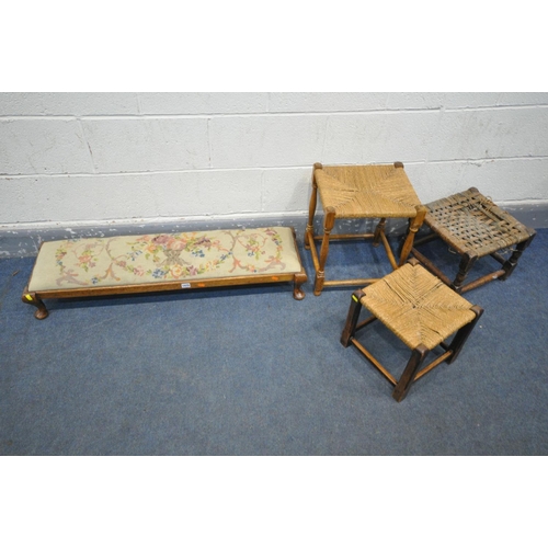 1474 - A LONG OAK NEEDLEWORK FOOTSTOOL, length 105cm, three rush topped stools (4)