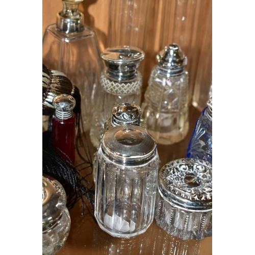 450 - A COLLECTION OF MAINLY EARLY 20TH CENTURY GLASS SCENT BOTTLES AND SIMILAR ITEMS, many with silver li... 