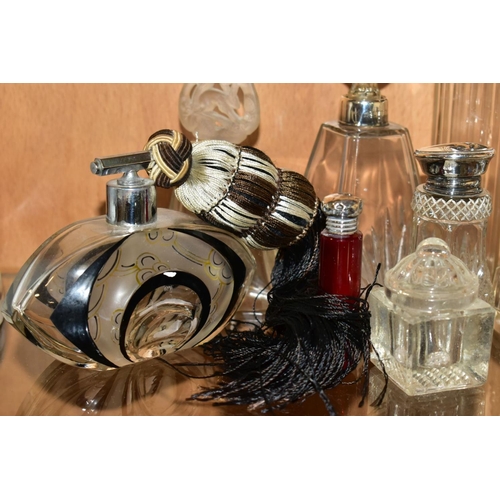 450 - A COLLECTION OF MAINLY EARLY 20TH CENTURY GLASS SCENT BOTTLES AND SIMILAR ITEMS, many with silver li... 