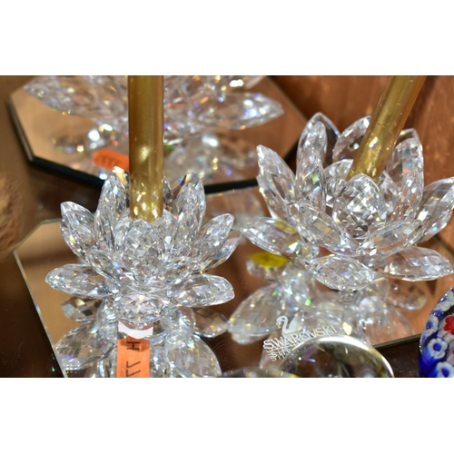 453 - THREE SWAROVSKI CRYSTAL CANDLEHOLDERS AND THREE GLASS PAPERWEIGHTS, comprising three Swarovski Water... 