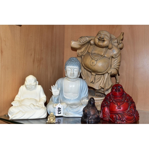 463 - SIX MODERN WOODEN, PORCELAIN AND RESIN BUDDHA FIGURES, including a wooden buddha with one raised leg... 