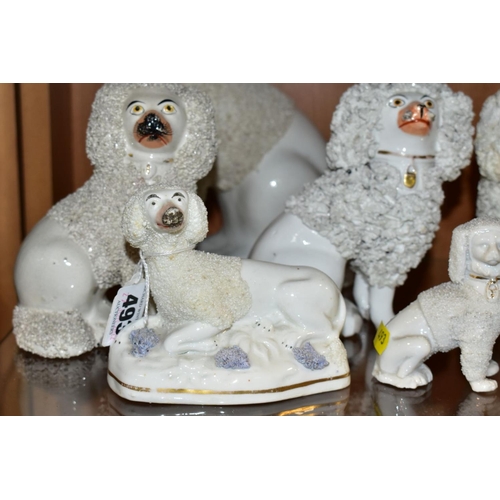 493 - SIX VICTORIAN STAFFORDSHIRE WHITE GLAZED AND FRIT DECORATED POODLE FIGURES AND A SIMILAR SMALL CONTI... 