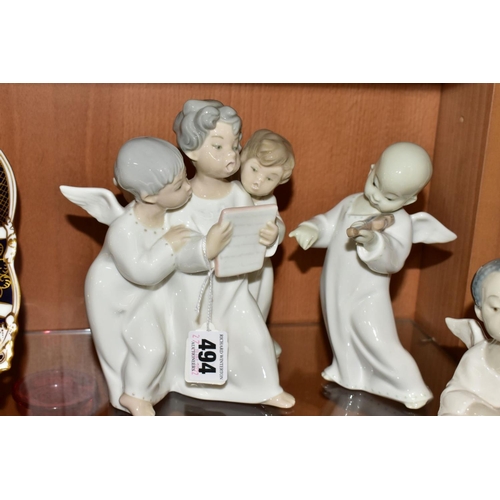 494 - THREE LLADRO FIGURES AND TWO LLADRO WALL MASKS, comprising  'Angel's Group', three angels singing fr... 