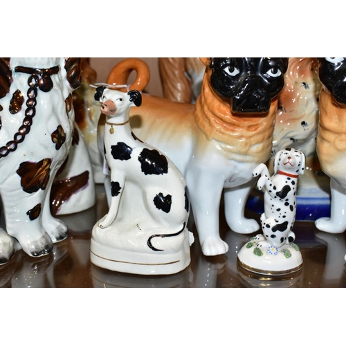 506 - NINE STAFFORDSHIRE/STAFFORDSHIRE STYLE DOGS, to include a pair of porcelain, probably German, pugs, ... 