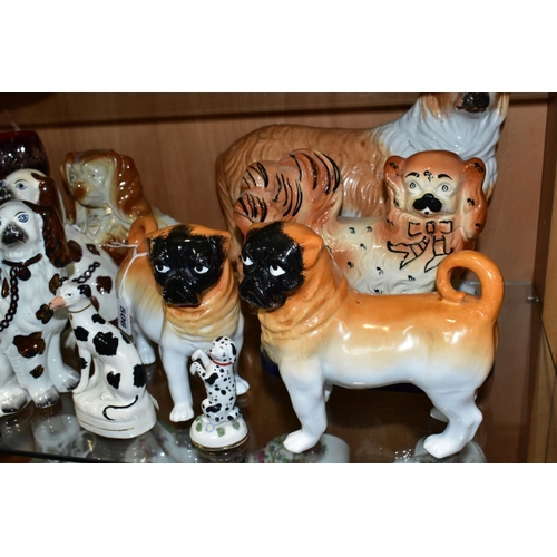 506 - NINE STAFFORDSHIRE/STAFFORDSHIRE STYLE DOGS, to include a pair of porcelain, probably German, pugs, ... 