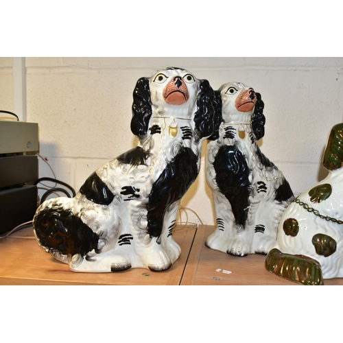 509 - THREE PAIRS OF STAFFORDSHIRE SPANIELS, comprising a pair with copper lustre details (lustre worn) he... 