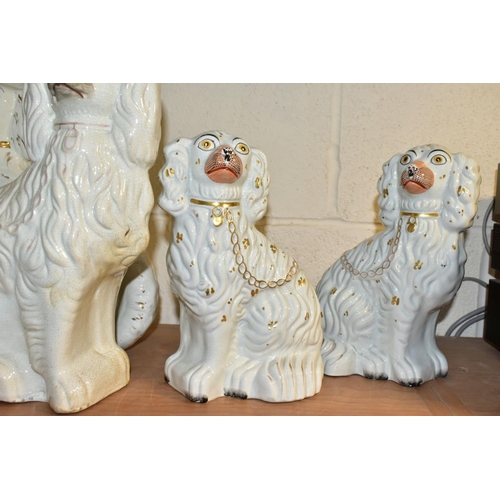 522 - SIX STAFFORDSHIRE SPANIELS, white glazed with gilt details, comprising two pairs approximate heights... 