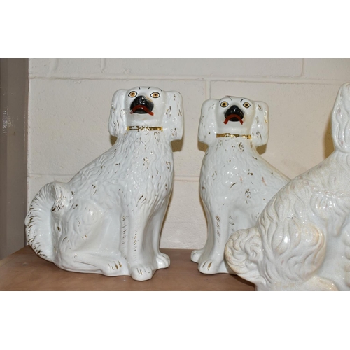 522 - SIX STAFFORDSHIRE SPANIELS, white glazed with gilt details, comprising two pairs approximate heights... 