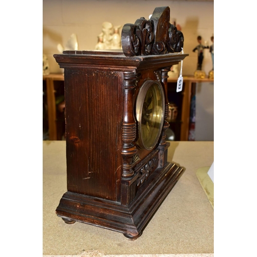 533 - A LATE 19TH CENTURY WALNUT AND STAINED MANTEL CLOCK, foliate carved pediment, printed dial with Roma... 