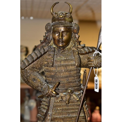 535 - A 20TH CENTURY PATINATED BRONZE FIGURE OF A SAMURAI  WARRIOR, cast as standing with a staff and hold... 