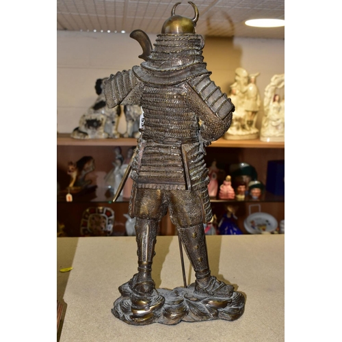 535 - A 20TH CENTURY PATINATED BRONZE FIGURE OF A SAMURAI  WARRIOR, cast as standing with a staff and hold... 