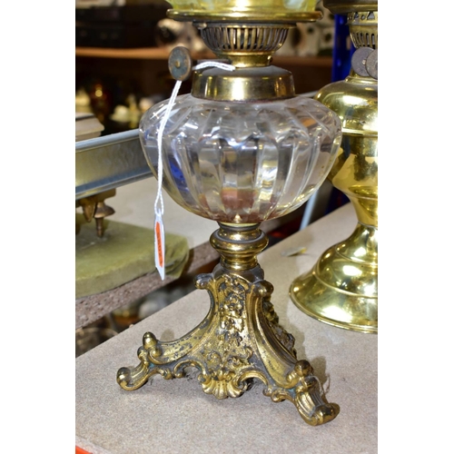 538 - A LATE VICTORIAN GILT METAL BASED OIL LAMP, with vaseline glass shade of wavy outline, the clear gla... 