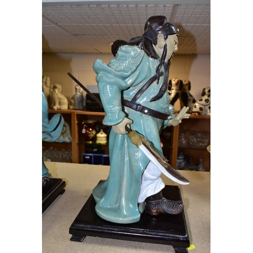 551 - A PAIR OF MODERN JAPANESE POTTERY FIGURES OF SAMURAI WARRIORS, posed holding bladed staff which is r... 