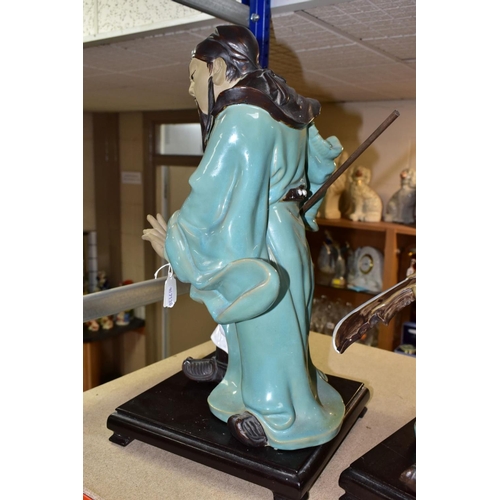 551 - A PAIR OF MODERN JAPANESE POTTERY FIGURES OF SAMURAI WARRIORS, posed holding bladed staff which is r... 