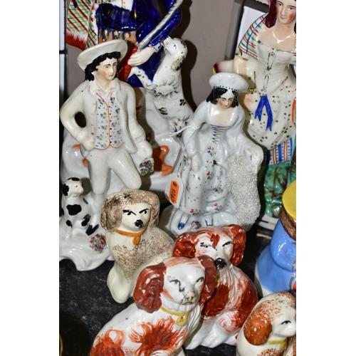 563 - A GROUP OF STAFFORDSHIRE/STAFFORDSHIRE STYLE FLATBACK FIGURES AND SPANIELS, to include a spill vase ... 