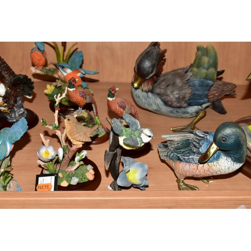 568 - A GROUP OF RESIN BIRD AND ANIMAL FIGURES, most having wooden bases to include a Breed Apart Lounger ... 