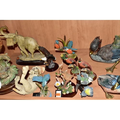 568 - A GROUP OF RESIN BIRD AND ANIMAL FIGURES, most having wooden bases to include a Breed Apart Lounger ... 