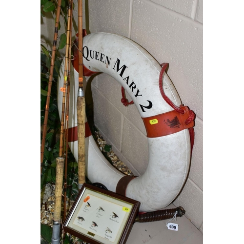 639 - FISHING INTEREST AND A LIFE RING, the life ring having decals reading 'Queen Mary 2' and rope attach... 