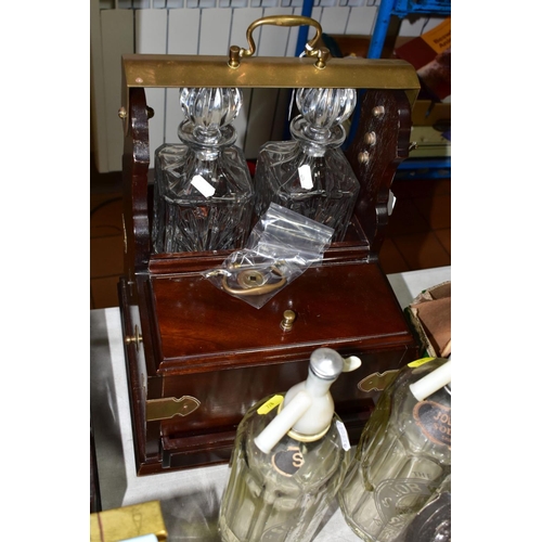 728 - A TANTALUS, SODA SYPHONS AND PLATED TEA WARES, the 20th century tantalus having key, two square deca... 