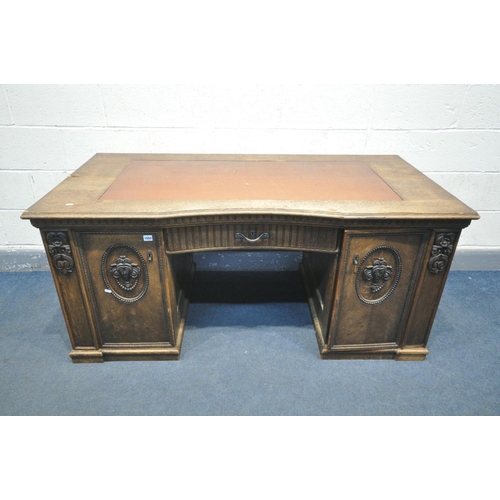 1650 - A FRENCH OAK KNEE HOLE DESK, with a leatherette writing surface, single drawer flanked by two cupboa... 