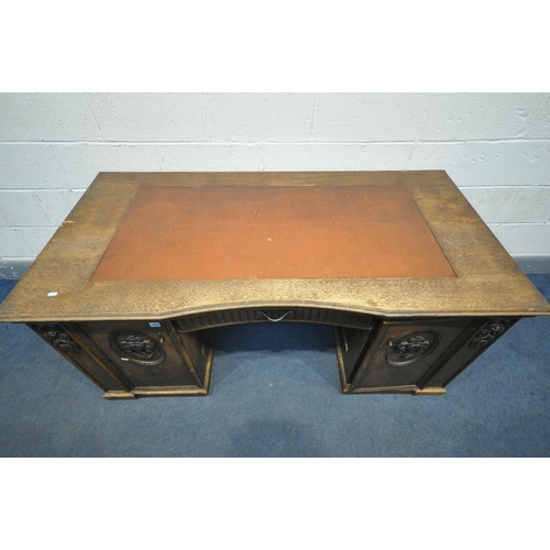 1650 - A FRENCH OAK KNEE HOLE DESK, with a leatherette writing surface, single drawer flanked by two cupboa... 