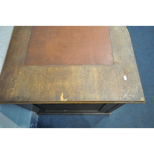 1650 - A FRENCH OAK KNEE HOLE DESK, with a leatherette writing surface, single drawer flanked by two cupboa... 