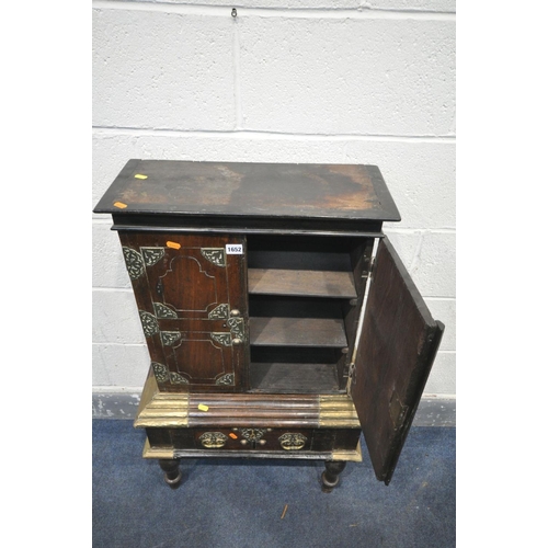 1652 - AN ANTIQUE HARDWOOD AND BRASS BANDED TWO DOOR CABINET, likely to be far Eastern, on a base with a si... 