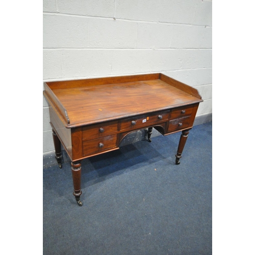 1665 - A VICTORIAN MAHOGANY DESK, with a gallery back and sides, five assorted drawers, on turned legs and ... 