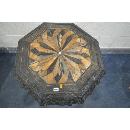 1667 - A 19TH CENTURY EBONISED CARVED WOOD OCTAGONAL TRIPOD OCCASIONAL TABLE, the top with a multi wood par... 