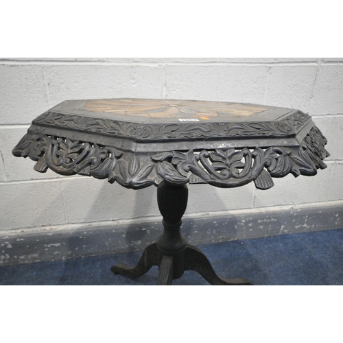 1667 - A 19TH CENTURY EBONISED CARVED WOOD OCTAGONAL TRIPOD OCCASIONAL TABLE, the top with a multi wood par... 