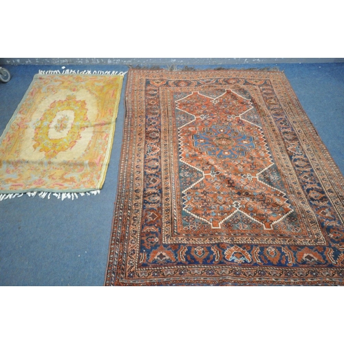 1669 - A 19TH CENTURY MIDDLE EASTERN HAND WOVEN RED HERIZ RUG, 160cm x 210cm, and a gold foliate rug (2)