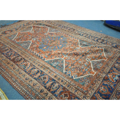 1669 - A 19TH CENTURY MIDDLE EASTERN HAND WOVEN RED HERIZ RUG, 160cm x 210cm, and a gold foliate rug (2)