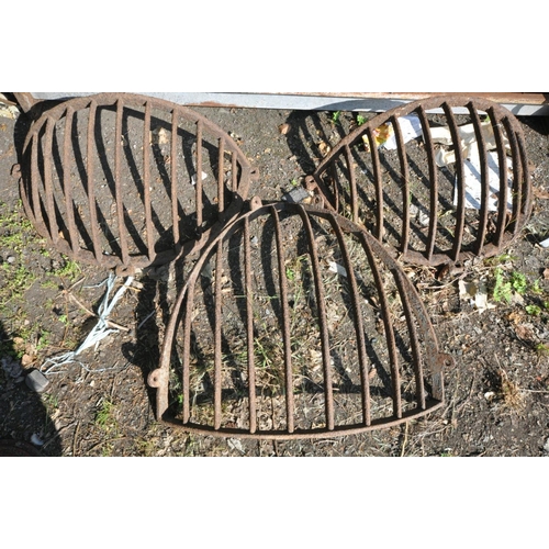 1201 - A VINTAGE CAST IRON CORNER HAY FEEDER, width 80cm x height 84cm, and a pair of vintage cast iron fla... 