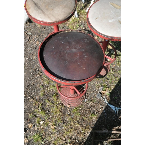 1205 - THREE ART DECO RED PAINTED METAL HIGH STOOLS, with a circular top, and footrest, on a stepped base, ... 