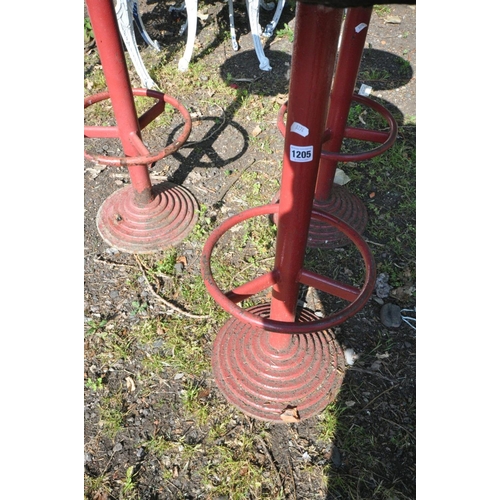 1205 - THREE ART DECO RED PAINTED METAL HIGH STOOLS, with a circular top, and footrest, on a stepped base, ... 