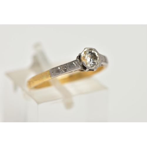 10 - A YELLOW AND WHITE METAL SINGLE STONE DIAMOND RING, collet mounted round brilliant cut diamond, esti... 