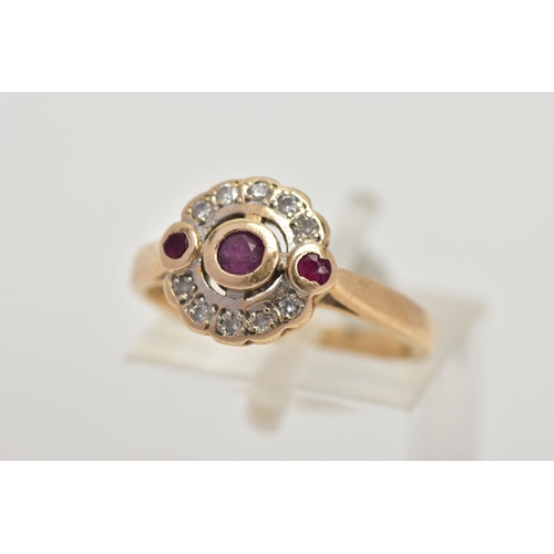 13 - A 15CT GOLD, DIAMOND AND RUBY CLUSTER RING, of a circular design, centring on a circular cut collet ... 