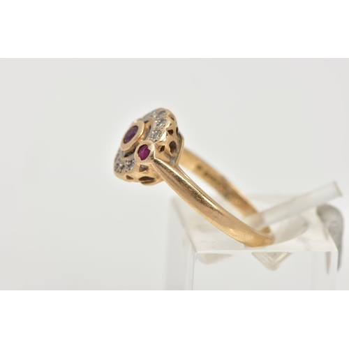 13 - A 15CT GOLD, DIAMOND AND RUBY CLUSTER RING, of a circular design, centring on a circular cut collet ... 