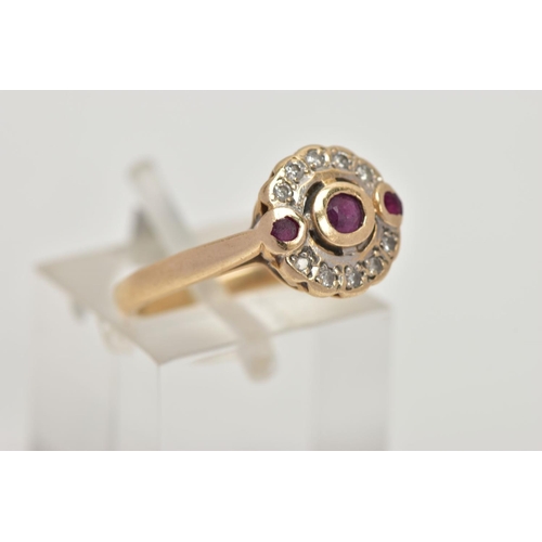 13 - A 15CT GOLD, DIAMOND AND RUBY CLUSTER RING, of a circular design, centring on a circular cut collet ... 