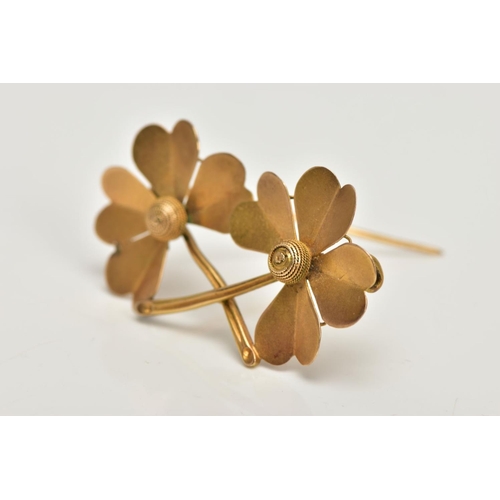 16 - A YELLOW METAL BROOCH, designed as a double four leaf clover, stamped to the reverse 15ct, fitted wi... 