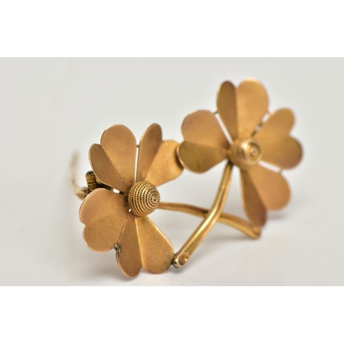 16 - A YELLOW METAL BROOCH, designed as a double four leaf clover, stamped to the reverse 15ct, fitted wi... 