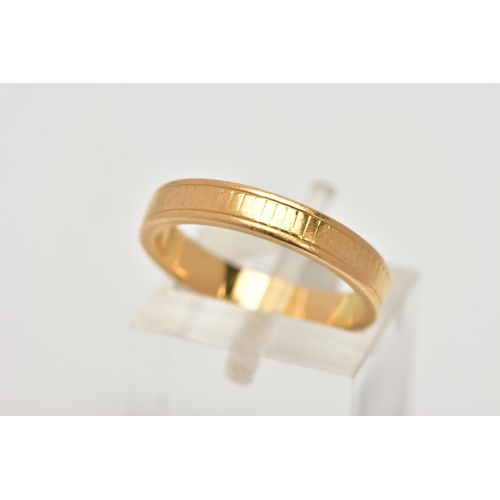 18 - A YELLOW METAL BAND RING, worn engraved detail all round, ring size M leading edge, unmarked, approx... 