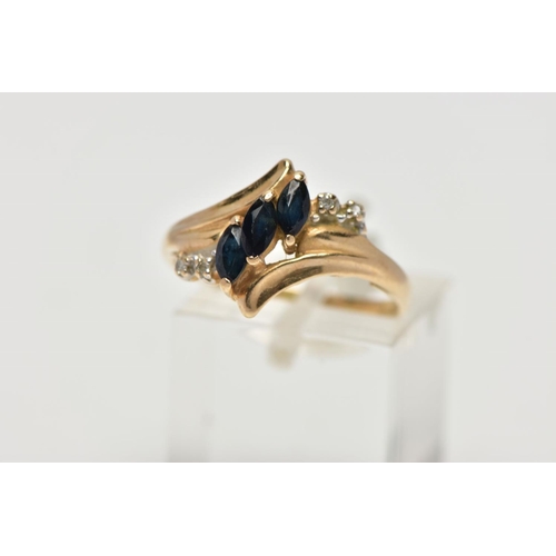 51 - A YELLOW METAL SAPPHIRE AND DIAMOND DRESS RING, of crossover design, set with three marquise cut sap... 