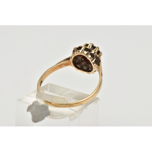 52 - A 9CT YELLOW GOLD GARNET SINGLE STONE RING, set with a circular cut garnet, within a textured border... 