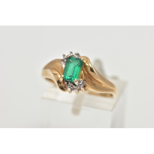 54 - A YELLOW METAL SYNTHETIC EMERALD AND DIAMOND RING, set with a rectangular cut synthetic emerald, wit... 