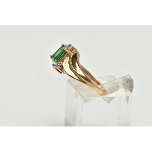 54 - A YELLOW METAL SYNTHETIC EMERALD AND DIAMOND RING, set with a rectangular cut synthetic emerald, wit... 